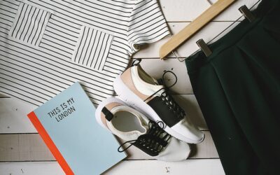 Editorial flat lay showing capsule wardrobe essentials in a neutral palette
