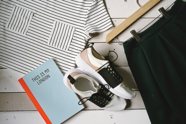 Editorial flat lay showing capsule wardrobe essentials in a neutral palette